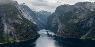 Narrow twisting channel of Geirangerfjord surrounded by steep mountains