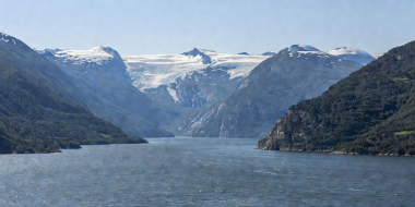 The wide expanse of Hardangerfjord opening towards distant glacier-capped plateau ridges